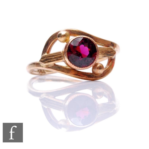 161 - A 9ct single stone almandine garnet ring, circular collar set stone to a slight twist, weight 2.5g, ... 