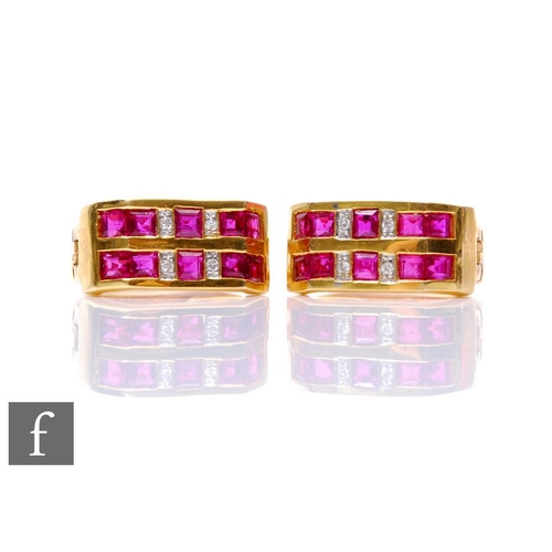 164 - A pair of 18ct ruby and diamond hinged hoop earrings, two rows of square cut rubies spaced by four d... 