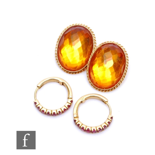 210 - A pair of 14ct facet cut oval citrine clip on earrings with rope twist borders, with a pair of unmar... 