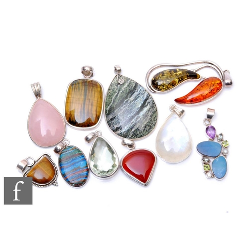 62 - Ten modern stone set silver mounted pendants to include amber, rose quartz and agate varieties. (10)