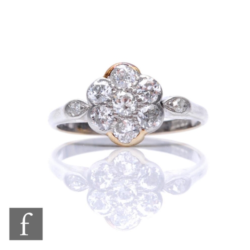 85 - An 18ct white gold diamond daisy cluster ring with diamond set shoulders, transitional cut stones, t... 