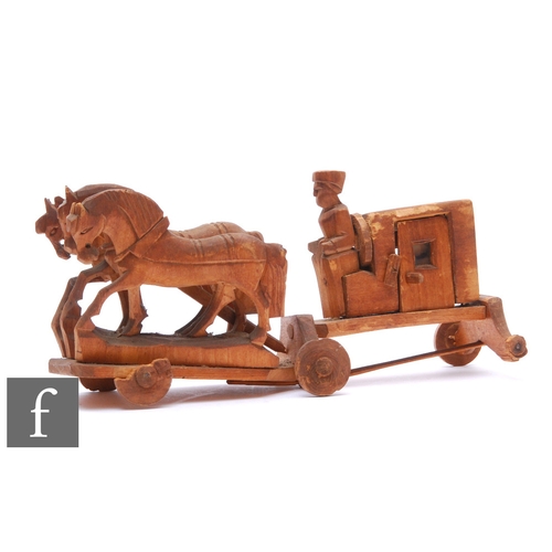 9072 - An early 20th Century Russian carved pine child's toy, modelled as a coach drawn by three horses, le... 
