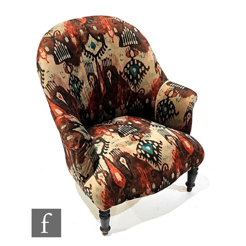 1011 - A late 19th Century salon easy chair upholstered in patterned fabric, raised to turned front legs, l... 