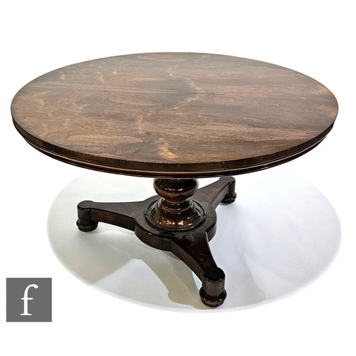 952 - A William IV rosewood tilt-top breakfast table of circular form, raised to a baluster turned support... 