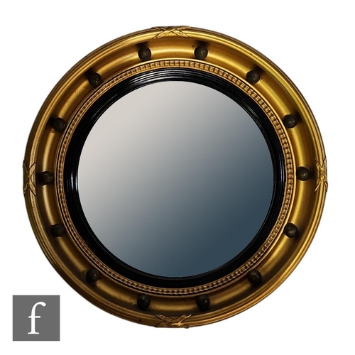 964 - A 20th Century Regency style circular gilt wall mirror with ebonised bezel and ball decoration, widt... 