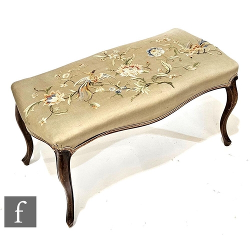 1012 - A Victorian walnut dressing stool on slender cabriole legs, the seat embroidered with exotic birds o... 