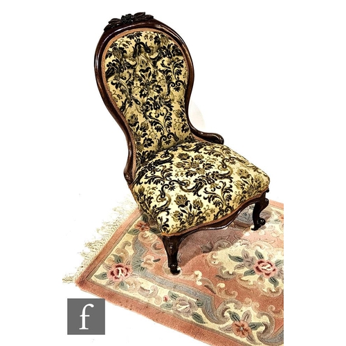 1014 - A Victorian carved walnut buttoned back easy chair on cabriole legs and ceramic castors to the front... 