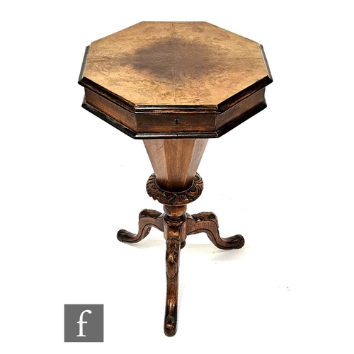 1015 - A Victorian walnut octagonal work table, fitted interior on carved tripod legs, width 43cm