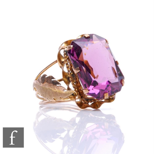 220 - A 14ct single stone amethyst ring, emerald cut, claw set stone with leaf detail to shoulders, weight... 