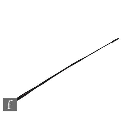 9078 - A late 19th and early 20th Century African hunting spear with single barb, shaped handle, carved and... 