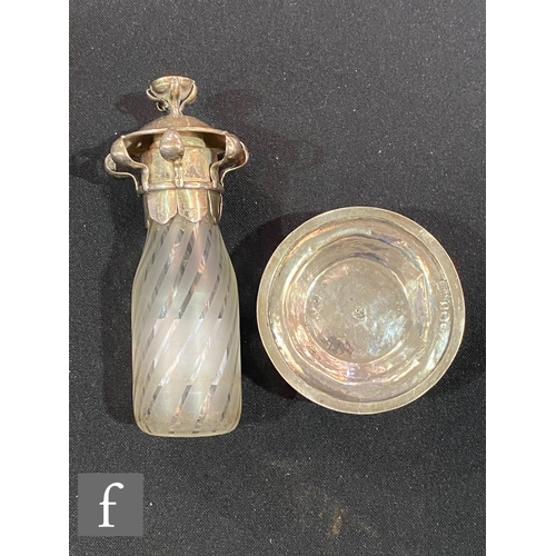 231 - A hallmarked silver and glass Arts & Crafts scent bottle, circular silver base supporting a part... 