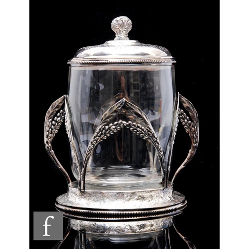 824 - A late 19th Century continental biscuit barrel in the manner of WMF, the clear crystal glass barrel ... 