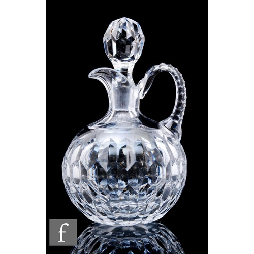 853 - A 20th Century clear crystal glass claret jug, of globular form with applied loop handle, heavily cu... 