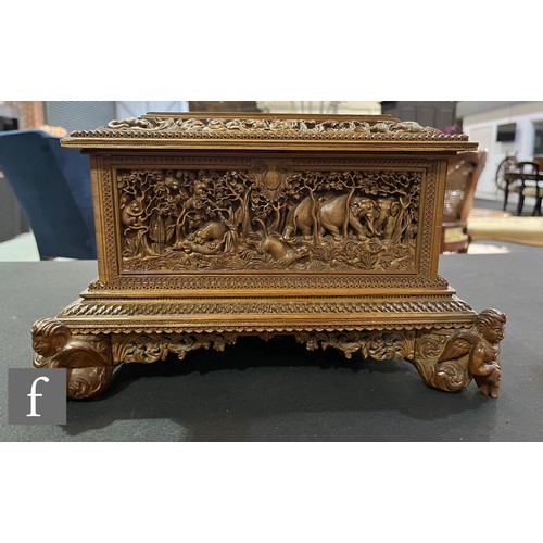 388 - A second quarter 20th Century hardwood table casket, carved in deep relief depicting elephants and t... 