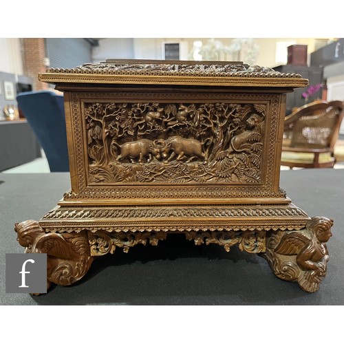 388 - A second quarter 20th Century hardwood table casket, carved in deep relief depicting elephants and t... 