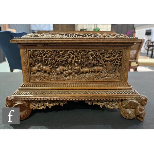 388 - A second quarter 20th Century hardwood table casket, carved in deep relief depicting elephants and t... 