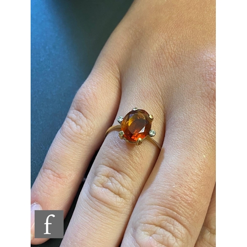 212 - A 18ct fire opal and diamond three stone ring, central oval claw set and flanked by a diamond to eac... 