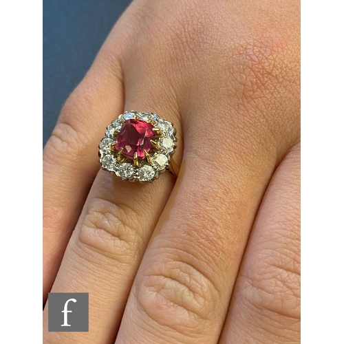 50 - AMENDED DESCRIPTION An 18ct paste and diamond cluster ring, central cushioned square ruby, length 7.... 