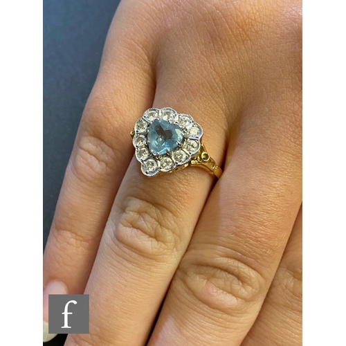 45 - An 18ct aquamarine and diamond cluster ring, heart shaped cut aquamarine within a border of eleven b... 