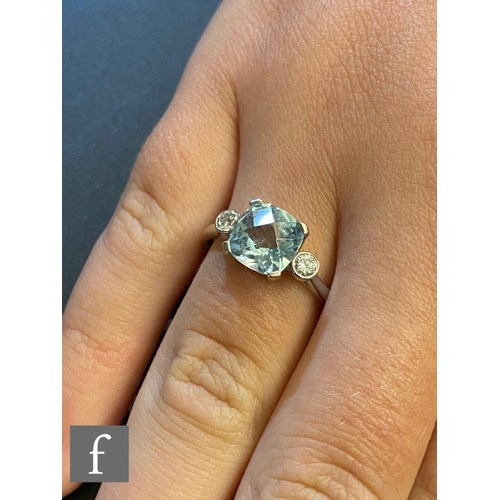 49 - An 18ct hallmarked white gold aquamarine and diamond three stone ring, cushioned square aquamarine f... 