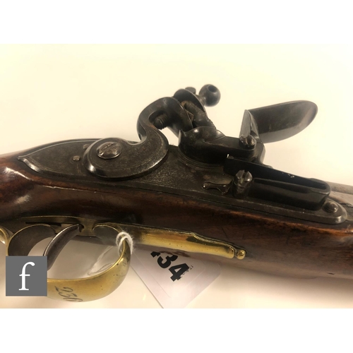 434 - An 18th Century flintlock pistol by H.Nock London, proof marked, 22cm barrel, the brass trigger guar... 