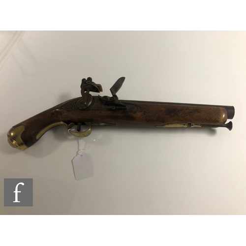 432 - A 19th Century flintlock holster pistol, 21cm barrel, tower mark, brass trigger guard and butt.