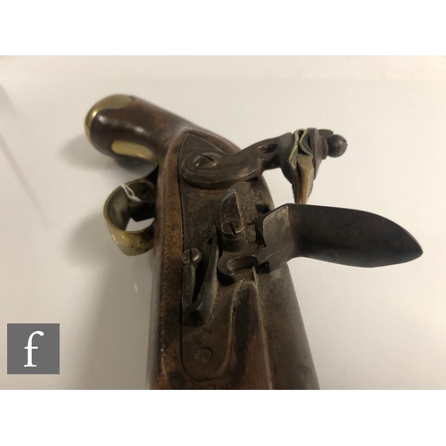 432 - A 19th Century flintlock holster pistol, 21cm barrel, tower mark, brass trigger guard and butt.