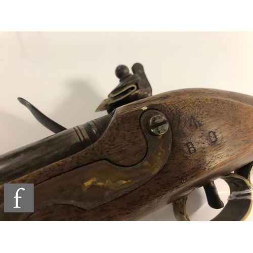 432 - A 19th Century flintlock holster pistol, 21cm barrel, tower mark, brass trigger guard and butt.