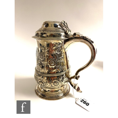 260 - A Georgian hallmarked silver tankard with later engraved decoration, terminating in hinged cover and... 