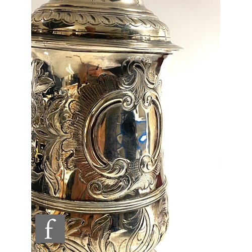 260 - A Georgian hallmarked silver tankard with later engraved decoration, terminating in hinged cover and... 