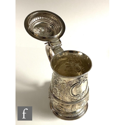 260 - A Georgian hallmarked silver tankard with later engraved decoration, terminating in hinged cover and... 