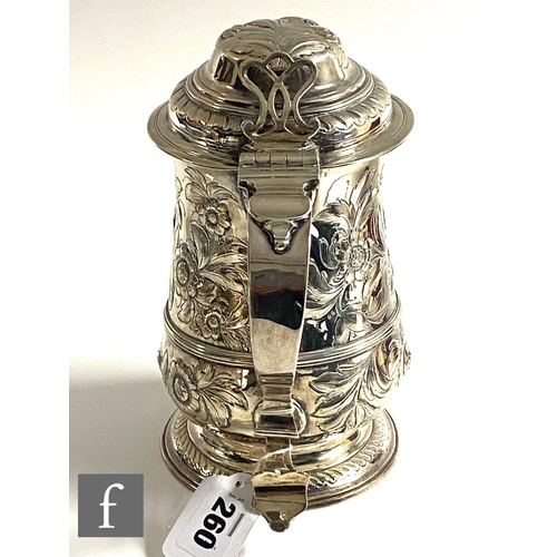 260 - A Georgian hallmarked silver tankard with later engraved decoration, terminating in hinged cover and... 