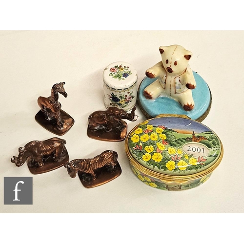 9075 - A 2001 Halcyon days enamel floral patch box, a similar box mounted with a bear, an enamelled cane to... 