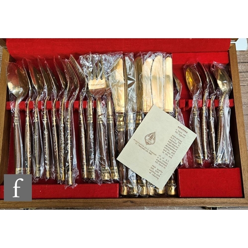 9081 - A 20th Century canteen of gilt cutlery for six settings, cased.