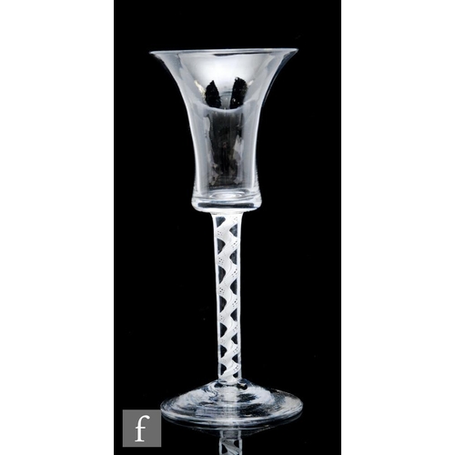 9103 - An 18th Century drinking glass circa 1750, the flared bucket form bowl above an air twist stem with ... 