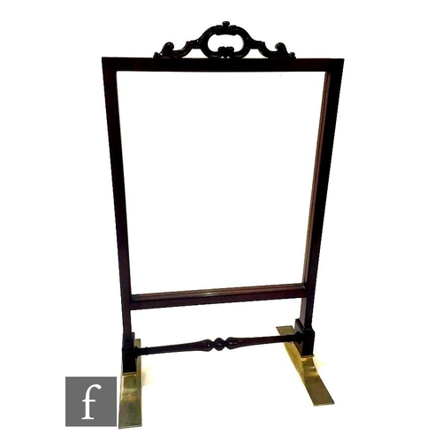 1088 - A late 19th Century mahogany floorstanding glazed firescreen, the handle of 'C' scroll design over r... 