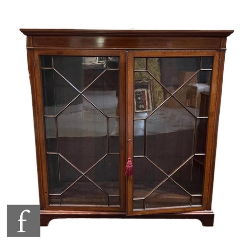 1091 - An Edwardian mahogany and satinwood cross-banded display cabinet, with astragal glazed double doors ... 