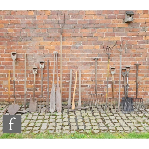 1123 - A pair of late 19th to early 20th Century brewing paddles with a selection of farm tools, to include... 