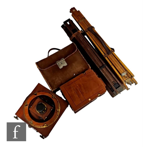 123 - A Thornton Pickard mahogany folding half plate camera 'Ruby', with four spare side plates and two tr... 