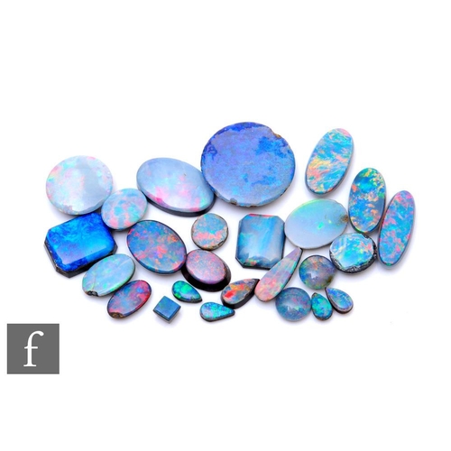 674 - Twenty five assorted loose opal doublets and triplets to include circular, oval and pear shaped exam... 