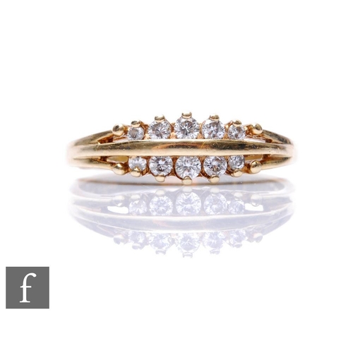 692 - A 9ct hallmarked diamond ring two rows of five brilliant cut stones spaced by a central gold bar, we... 