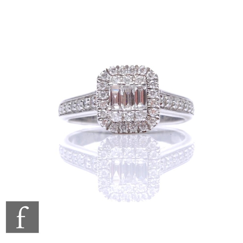 697 - A 9ct white gold diamond cluster ring, cushioned rectangular head set with baguette and brilliant cu... 