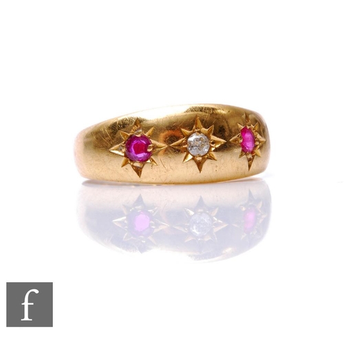 700 - An 18ct hallmarked ruby and diamond three stone ring, gypsy set stones to a plain boat shaped head, ... 