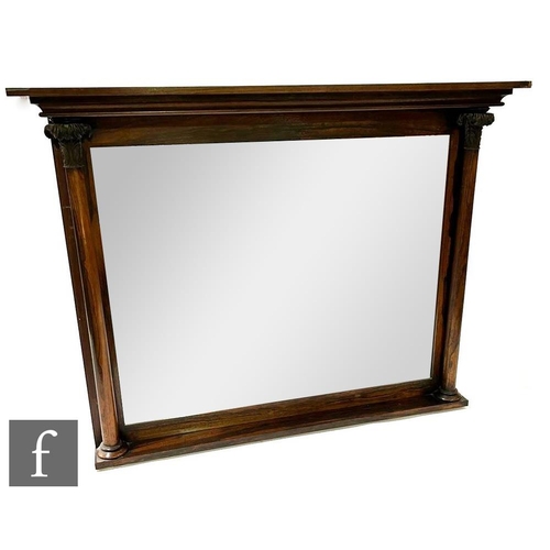 1102 - A 19th Century simulated rosewood overmantel mirror, the cornice pediment above twin acanthus capped... 