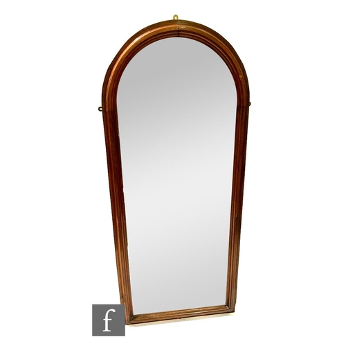 1103 - A late 20th Century walnut framed arched shaped pier mirror, bearing John Gibbons Ltd label to the r... 