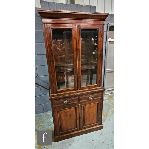 1099 - A Victorian walnut cabinet bookcase, with cornice pediment above glazed double doors, two drawers an... 