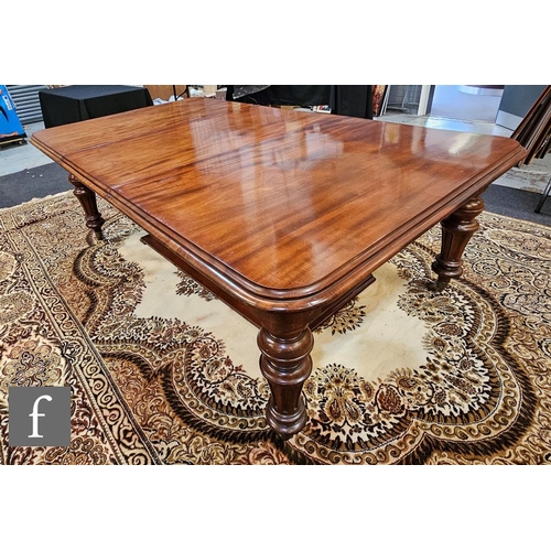 1097 - A Victorian mahogany wind-out extending dining table of rounded rectangular form, complete with thre... 