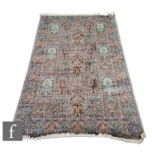 1090 - A modern Kashmir silk carpet, decorated with repeat panels of trees in salmon pink, sage green and b... 