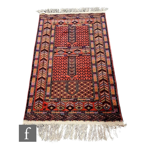 1112 - A modern Afghan Turkman rug, with multi-coloured geometric pattern on a rust coloured ground, 172cm ... 