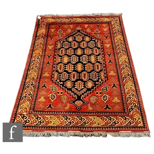 1113 - A modern Hamadan rug with large blue medallion within repeat pattern motifs, all on a rust coloured ... 